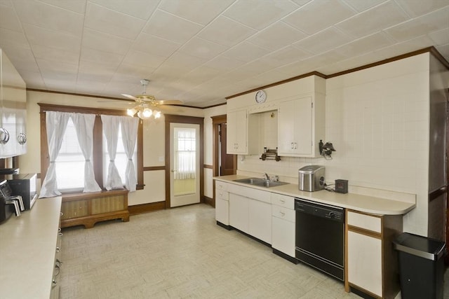 kitchen featuring black dishwasher, light floors, light countertops, white cabinets, and a sink