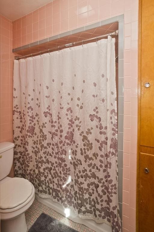 bathroom with toilet, tile patterned flooring, and a shower with shower curtain