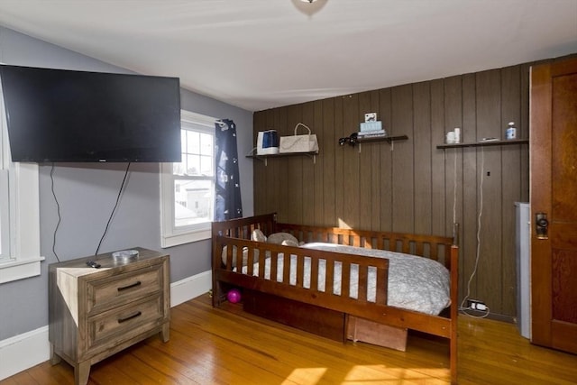 bedroom with light wood-style floors and baseboards