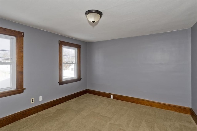 carpeted empty room with baseboards