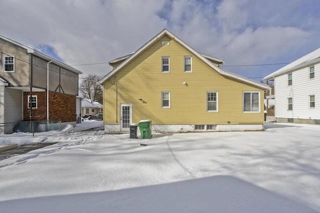 view of snow covered rear of property