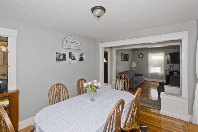 dining room with baseboards and wood finished floors