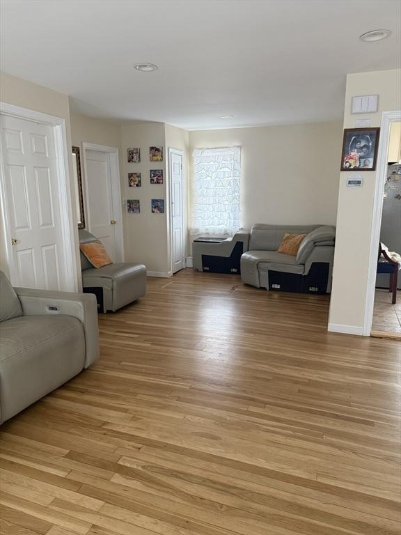 living room featuring light wood finished floors and baseboards