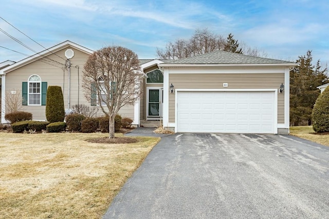 ranch-style house with aphalt driveway, a front yard, and an attached garage