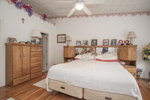 bedroom featuring a ceiling fan and wood finished floors