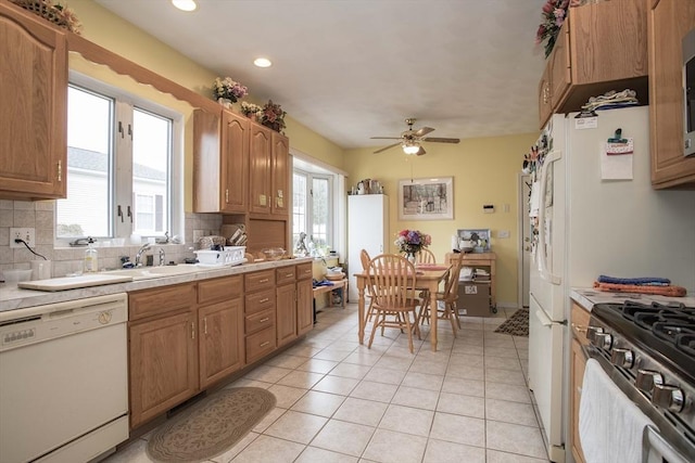 kitchen with stainless steel appliances, light countertops, and decorative backsplash