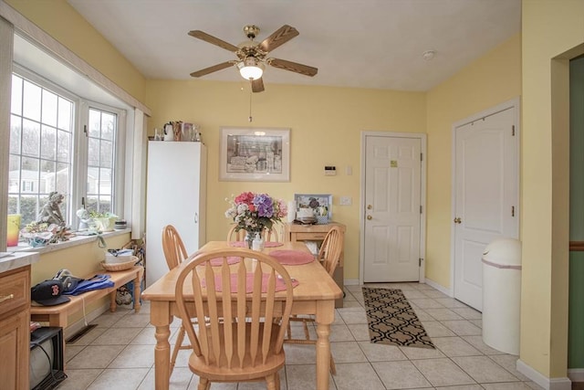 dining room with light tile patterned floors, ceiling fan, and baseboards