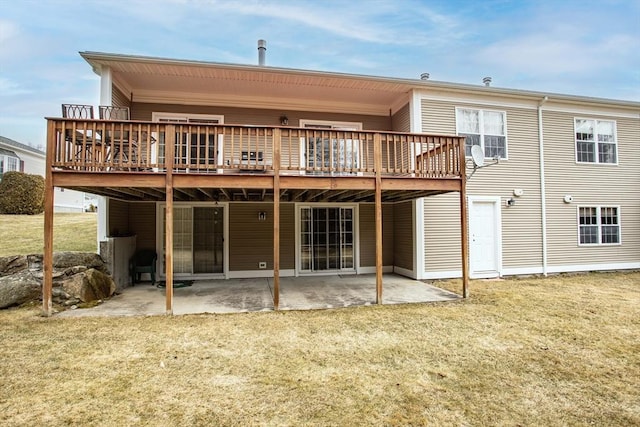 rear view of property with a deck, a patio, and a yard