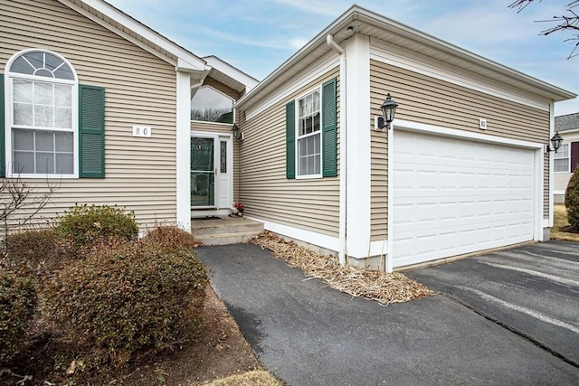 exterior space with driveway and an attached garage