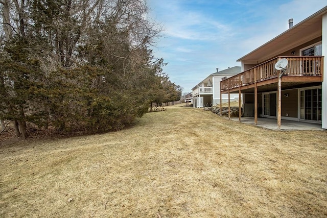 view of yard featuring a patio area and a wooden deck