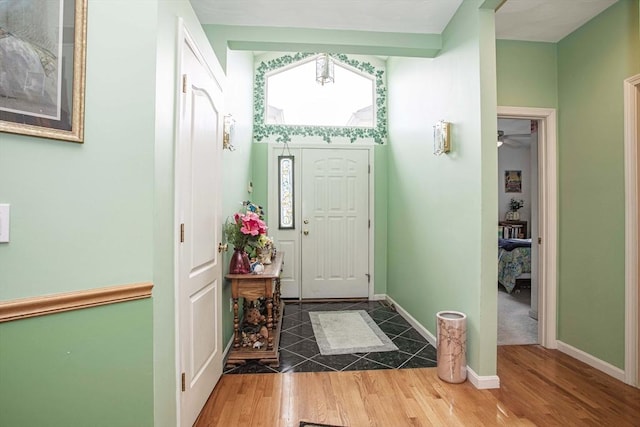 entrance foyer featuring baseboards and wood finished floors