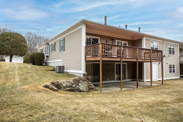 rear view of house featuring a patio, central AC unit, a lawn, and a wooden deck