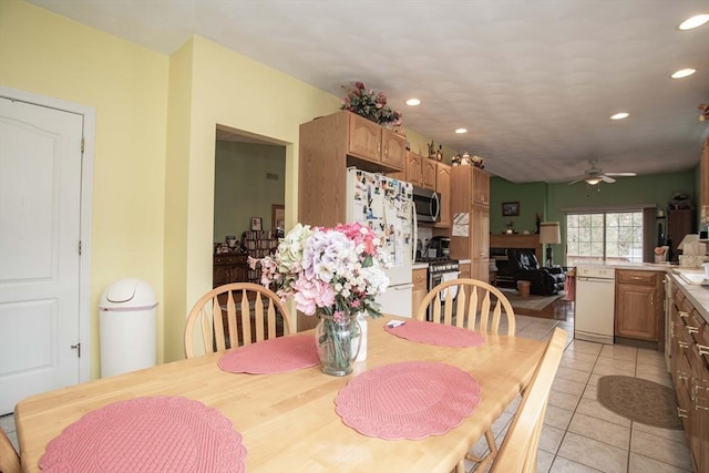 dining space with light tile patterned flooring, a ceiling fan, and recessed lighting