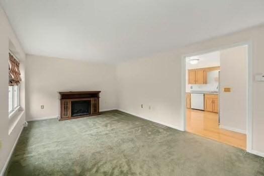 5 Saint John Ln Unit 5, Milford, MA 01757 - unfurnished living room with light colored carpet and a fireplace
