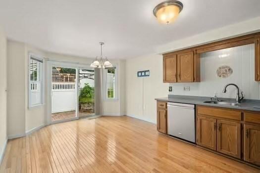 5 Saint John Ln Unit 5, Milford, MA 01757 - kitchen featuring dishwasher, brown cabinets, a chandelier, light wood finished floors, and decorative light fixtures