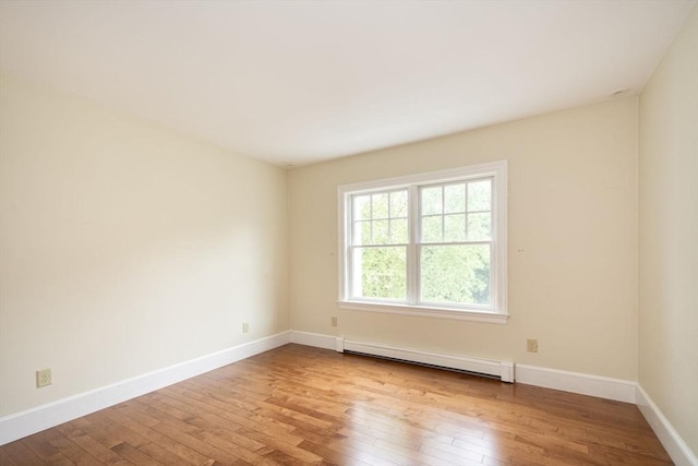 265 King St, Cohasset, MA 02025 - empty room featuring a baseboard heating unit and hardwood / wood-style floors
