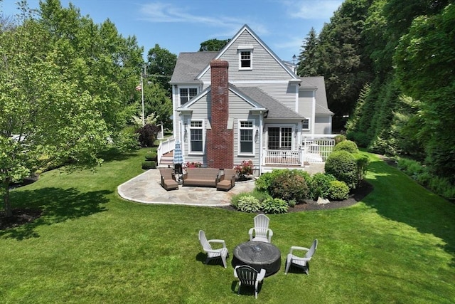 265 King St, Cohasset, MA 02025 - rear view of property with a patio, an outdoor living space with a fire pit, a yard, and a shingled roof