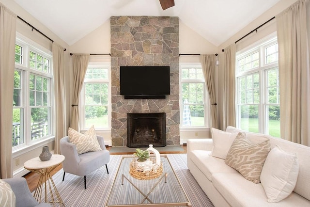 265 King St, Cohasset, MA 02025 - living room featuring lofted ceiling, healthy amount of natural light, a stone fireplace, and wood finished floors