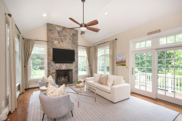 265 King St, Cohasset, MA 02025 - living area with healthy amount of natural light, a ceiling fan, wood finished floors, lofted ceiling, and a stone fireplace