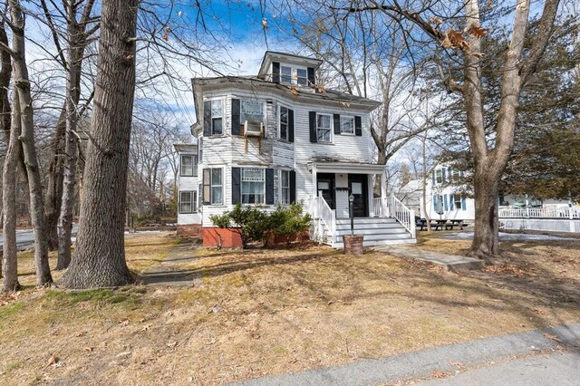 american foursquare style home featuring cooling unit