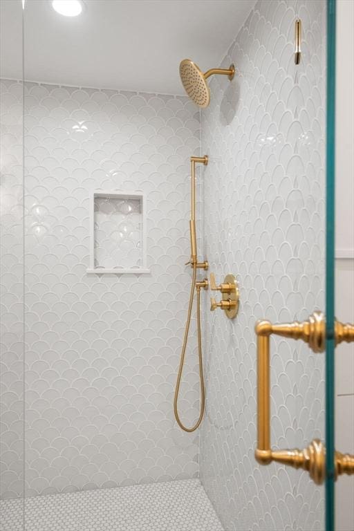 bathroom with a shower with door