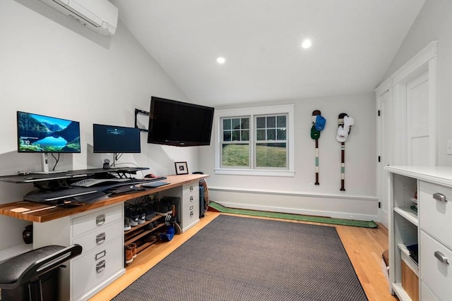 office space with lofted ceiling, light hardwood / wood-style flooring, and an AC wall unit