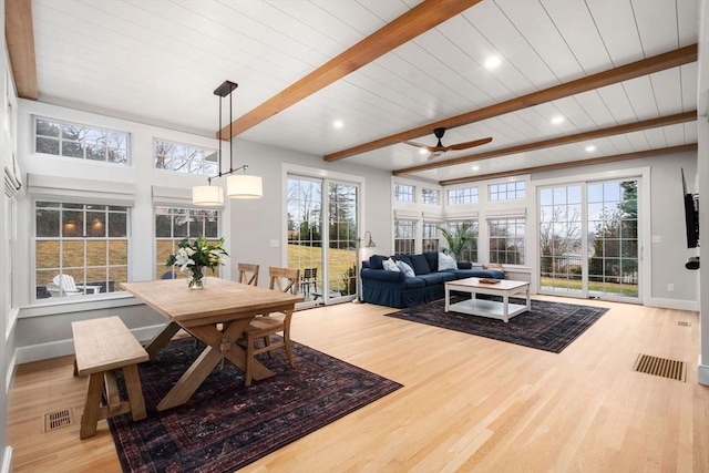 sunroom with beamed ceiling and ceiling fan