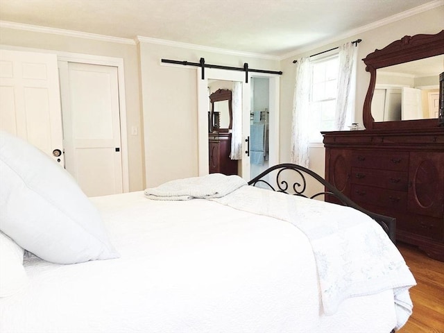 15 Sudbury Rd, Stow, MA 01775 - bedroom with crown molding, a barn door, wood finished floors, and ensuite bath