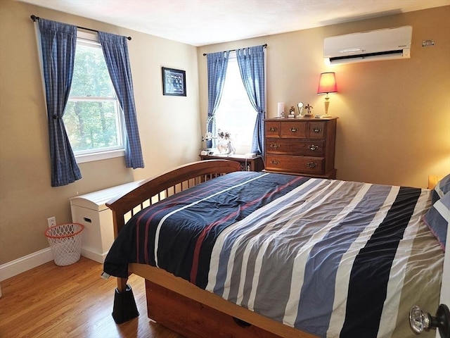 15 Sudbury Rd, Stow, MA 01775 - bedroom with a wall mounted air conditioner and wood finished floors