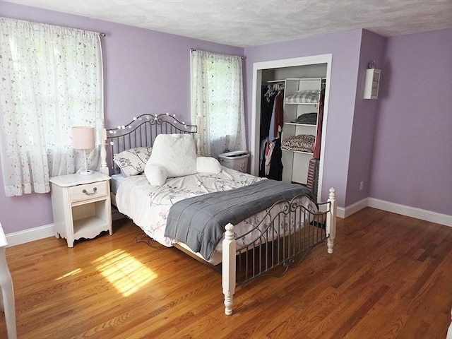 15 Sudbury Rd, Stow, MA 01775 - bedroom featuring wood finished floors, a closet, and a textured ceiling