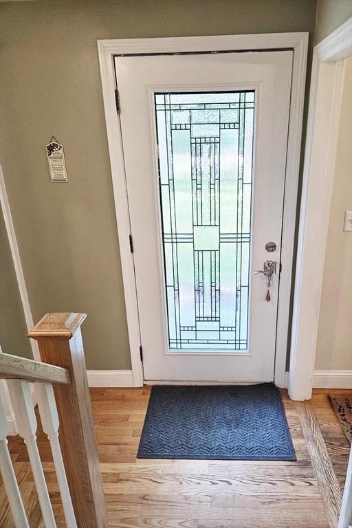 15 Sudbury Rd, Stow, MA 01775 - doorway to outside with baseboards and light wood finished floors