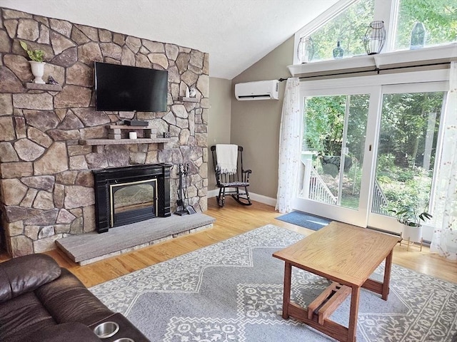 15 Sudbury Rd, Stow, MA 01775 - living room with a wall unit AC, a fireplace, vaulted ceiling, and wood finished floors