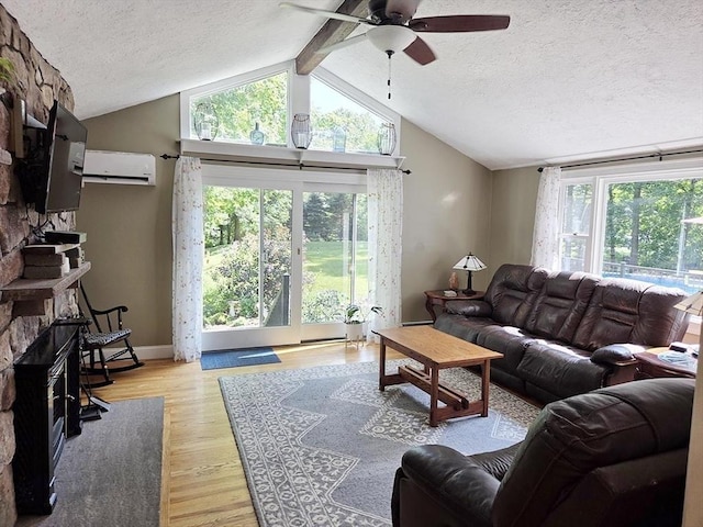 15 Sudbury Rd, Stow, MA 01775 - living area featuring ceiling fan, a wall mounted air conditioner, a textured ceiling, vaulted ceiling, and light wood-style flooring