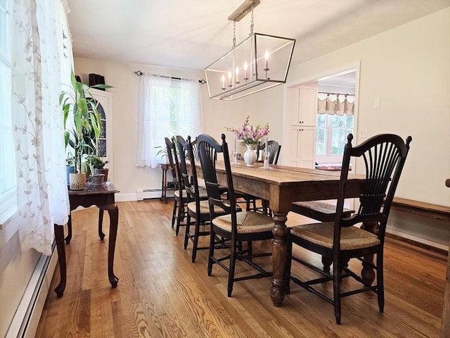 15 Sudbury Rd, Stow, MA 01775 - dining area with a baseboard radiator, wood finished floors, healthy amount of natural light, and a chandelier