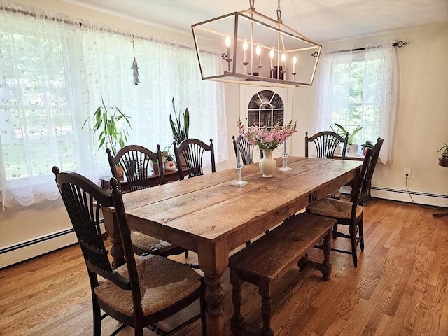 15 Sudbury Rd, Stow, MA 01775 - dining room featuring baseboard heating, a chandelier, and light wood-style flooring