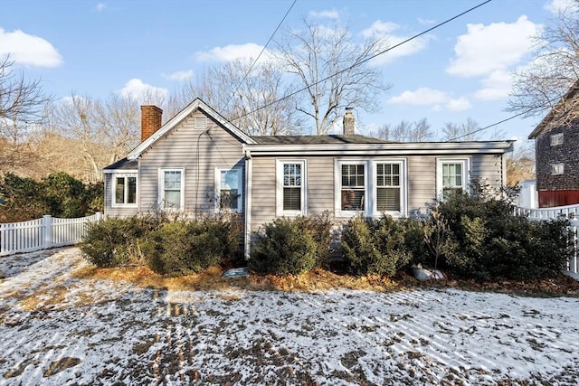 view of snow covered rear of property