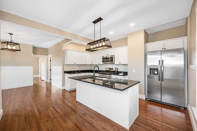 11-13 Read St, Lowell, MA 01850 - kitchen with appliances with stainless steel finishes, a sink, dark wood-style floors, a center island with sink, and wainscoting