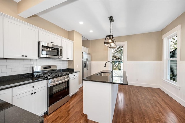 11-13 Read St, Lowell, MA 01850 - kitchen with stainless steel appliances, a sink, wainscoting, dark wood-type flooring, and white cabinets