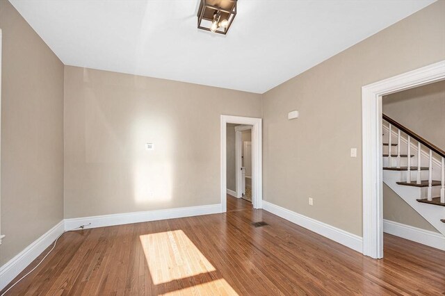 11-13 Read St, Lowell, MA 01850 - empty room featuring wood finished floors, baseboards, and stairway