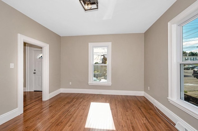 11-13 Read St, Lowell, MA 01850 - spare room with healthy amount of natural light, wood finished floors, and baseboards