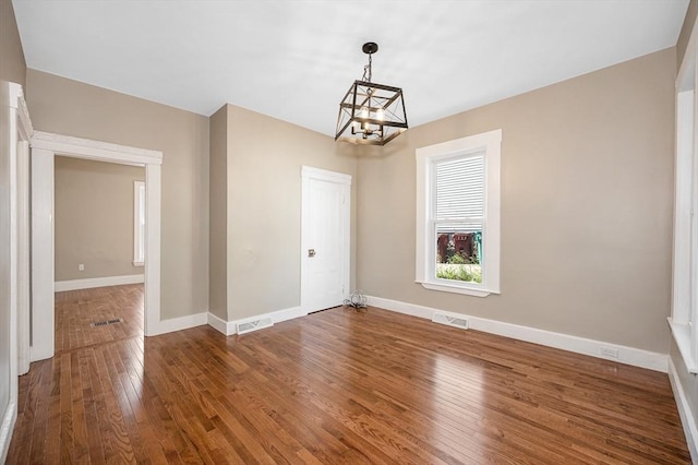 11-13 Read St, Lowell, MA 01850 - unfurnished dining area featuring a chandelier, wood-type flooring, and baseboards