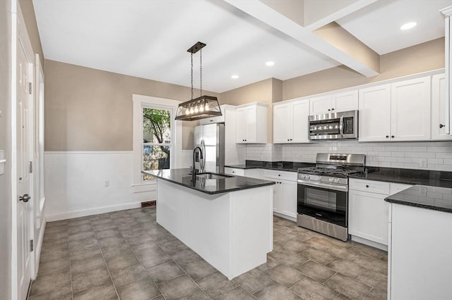 11-13 Read St, Lowell, MA 01850 - kitchen with stainless steel appliances, a sink, decorative backsplash, white cabinets, and recessed lighting