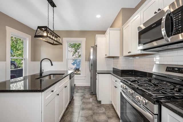 11-13 Read St, Lowell, MA 01850 - kitchen with appliances with stainless steel finishes, a sink, healthy amount of natural light, white cabinets, and recessed lighting