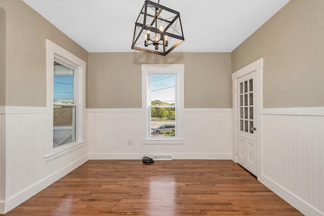 11-13 Read St, Lowell, MA 01850 - unfurnished dining area with a chandelier, wainscoting, and wood finished floors
