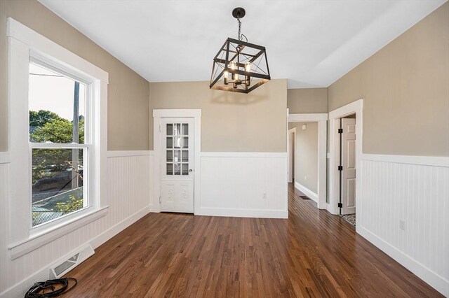 11-13 Read St, Lowell, MA 01850 - unfurnished dining area with a chandelier, a wainscoted wall, and dark wood-style floors