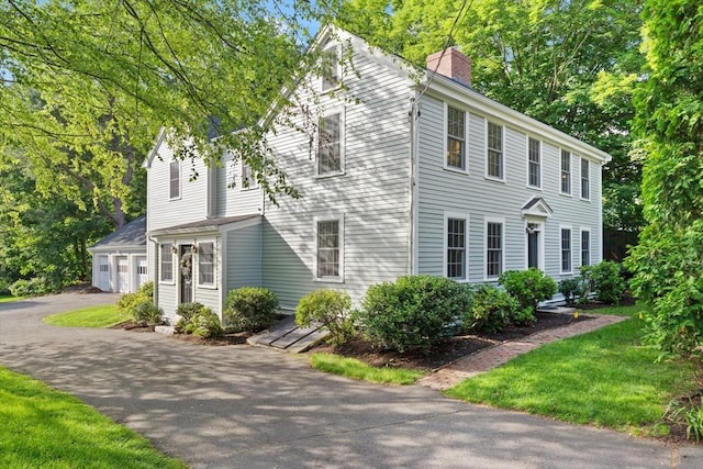 1395 Canton Ave, Milton, MA 02186 - view of front of house with a chimney and asphalt driveway