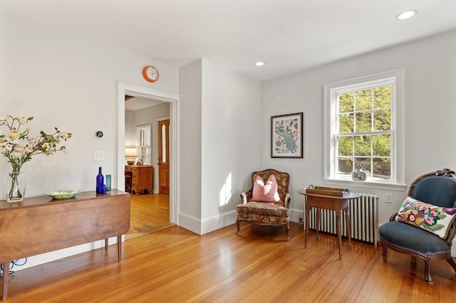 1395 Canton Ave, Milton, MA 02186 - living area featuring radiator heating unit, light wood-style floors, and recessed lighting