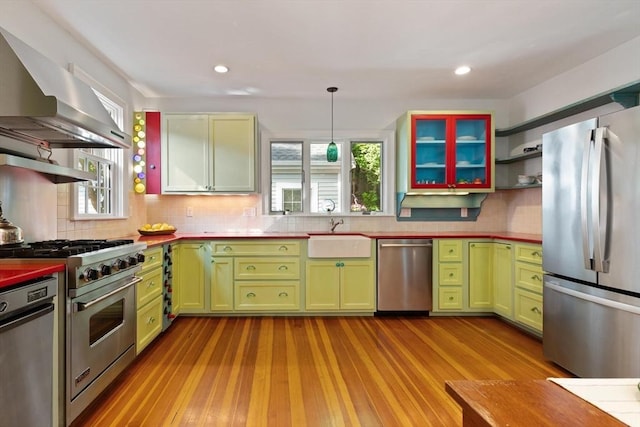 1395 Canton Ave, Milton, MA 02186 - kitchen featuring stainless steel appliances, open shelves, wall chimney range hood, green cabinetry, and recessed lighting