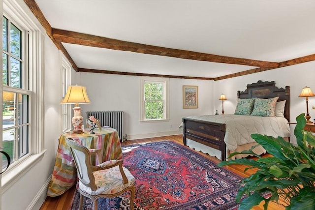 1395 Canton Ave, Milton, MA 02186 - bedroom with radiator, beam ceiling, and wood finished floors