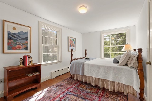 1395 Canton Ave, Milton, MA 02186 - bedroom featuring baseboard heating, wood finished floors, and multiple windows